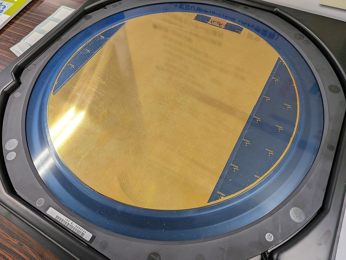 Close-up of a silicon wafer covered in a dense grid of microchips