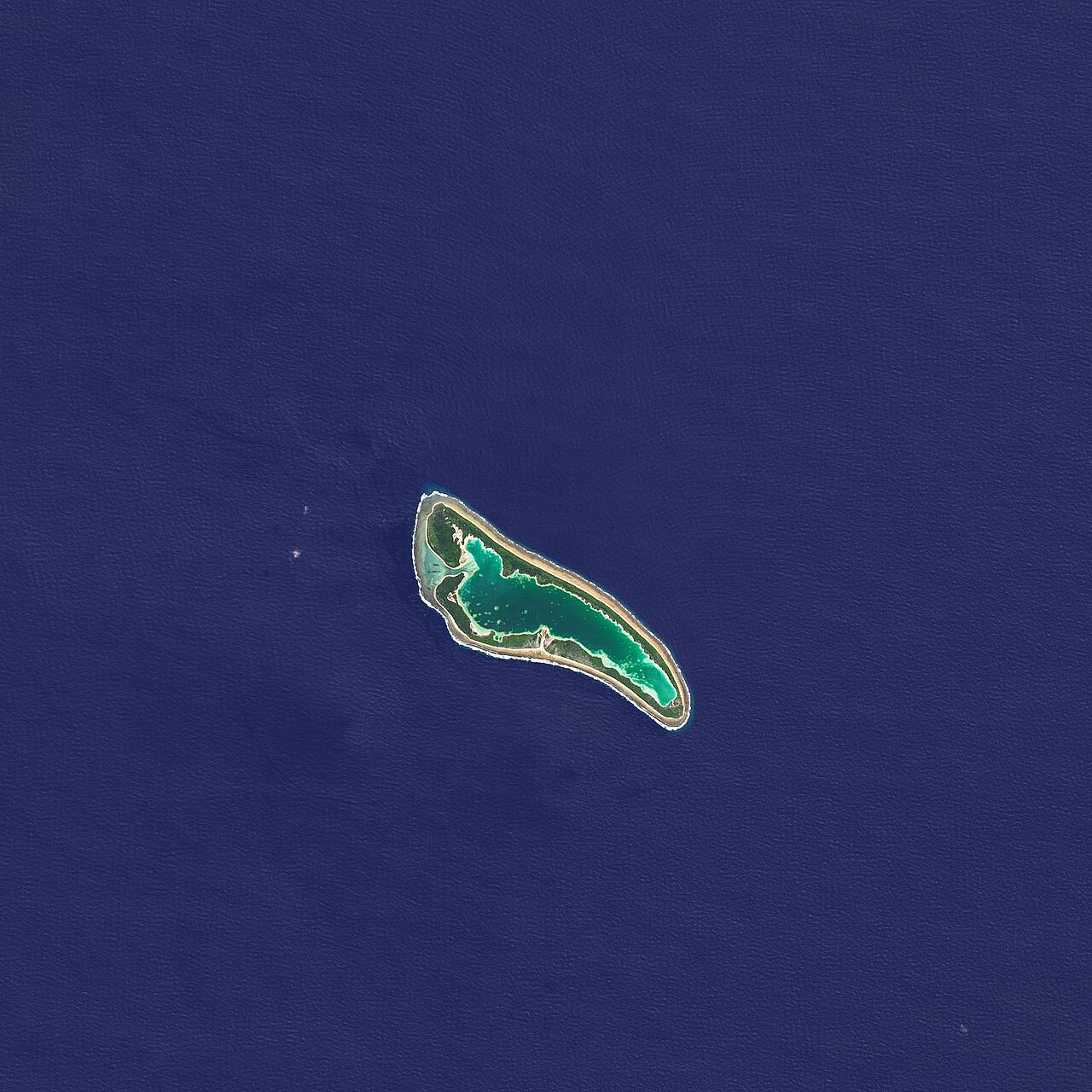 Satellite view of Nikumaroro, a ring-shaped coral atoll around a turquoise lagoon in the Pacific
